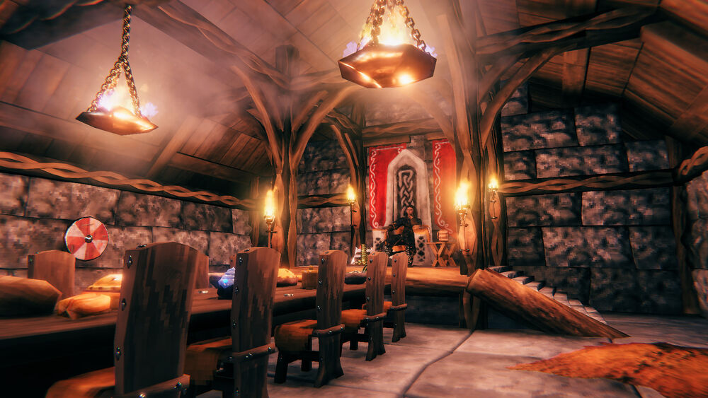 Official Valheim screenshot of a cozy longhouse interior